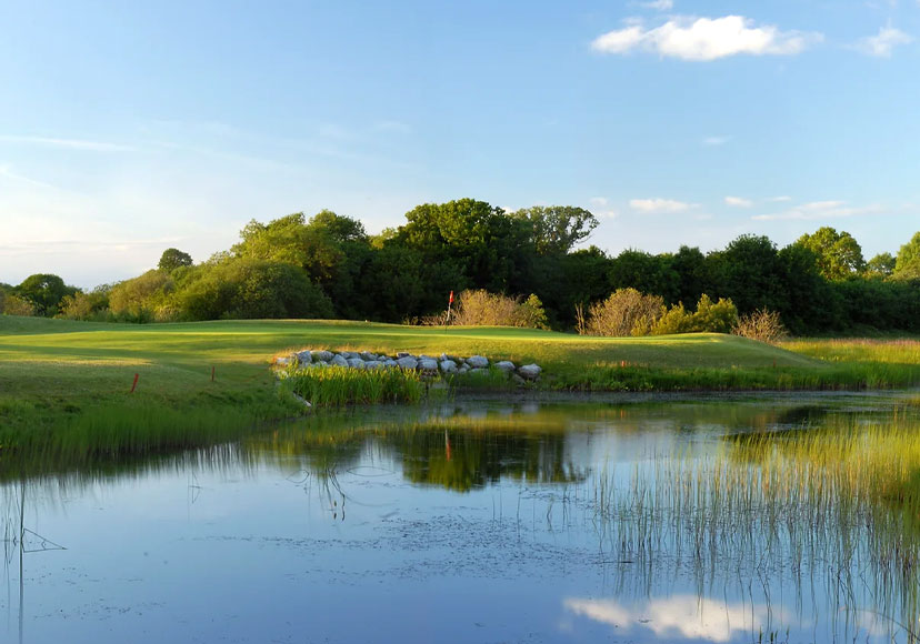 View of green across a lake at Athlone Golf Club.